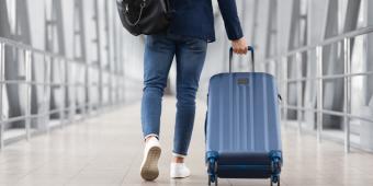 person walking with suitcase